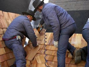 Amish crew install cedar shingles in Pella, Iowa